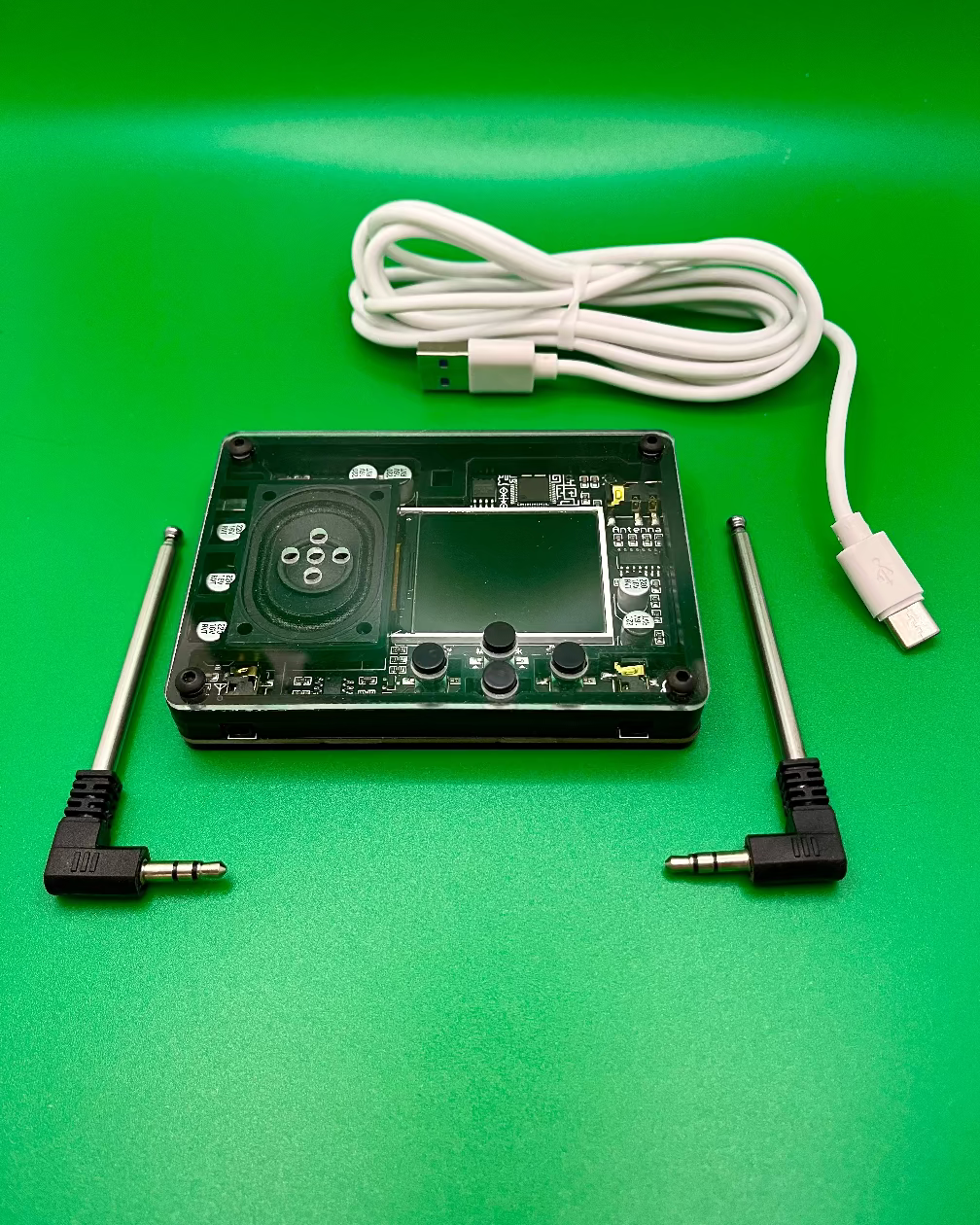 Electronic device with antennas and USB cable on a green background